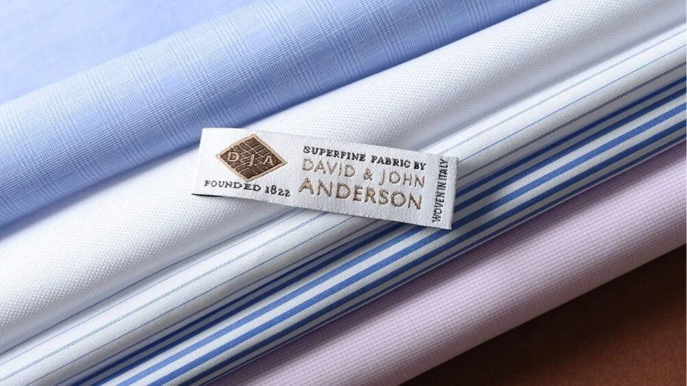 Stacked blue and white David and John Anderson shirtings with the Founded 1822 superfine fabric label