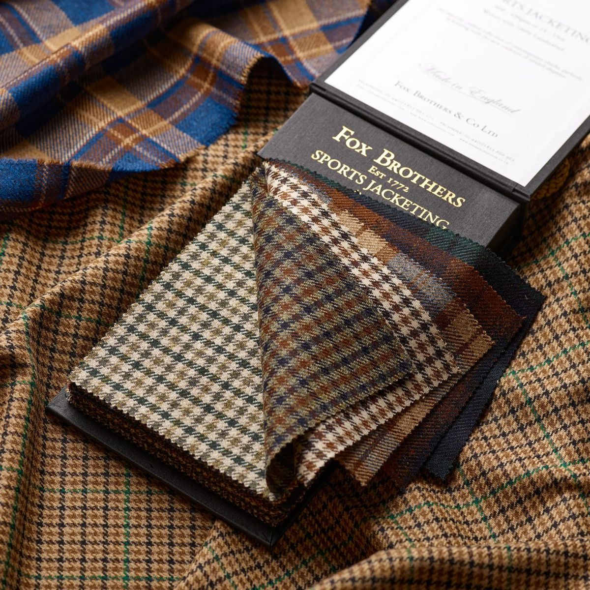 Fox Brothers sporting jacketing in tan and brown checks with the house swatch wallet