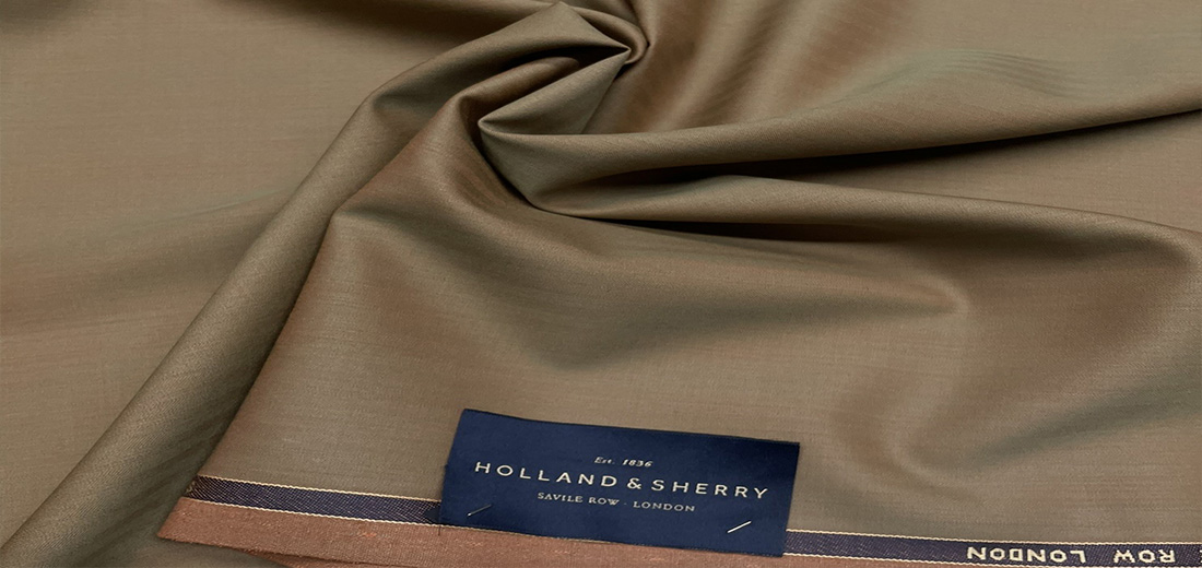 Olive Holland and Sherry cloth draped to show the navy Savile Row London selvedge label