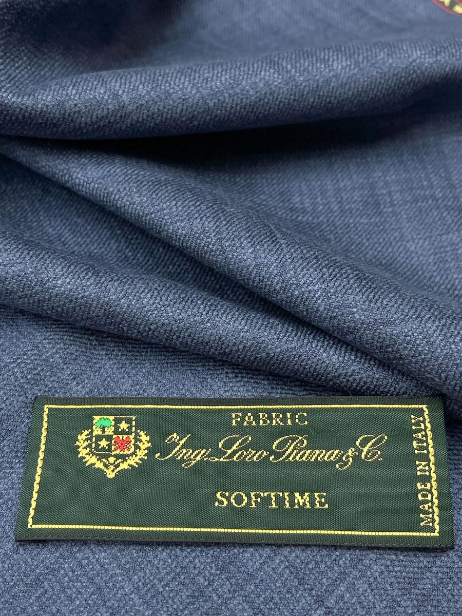 Blue Loro Piana cloth folded beside its Softime label