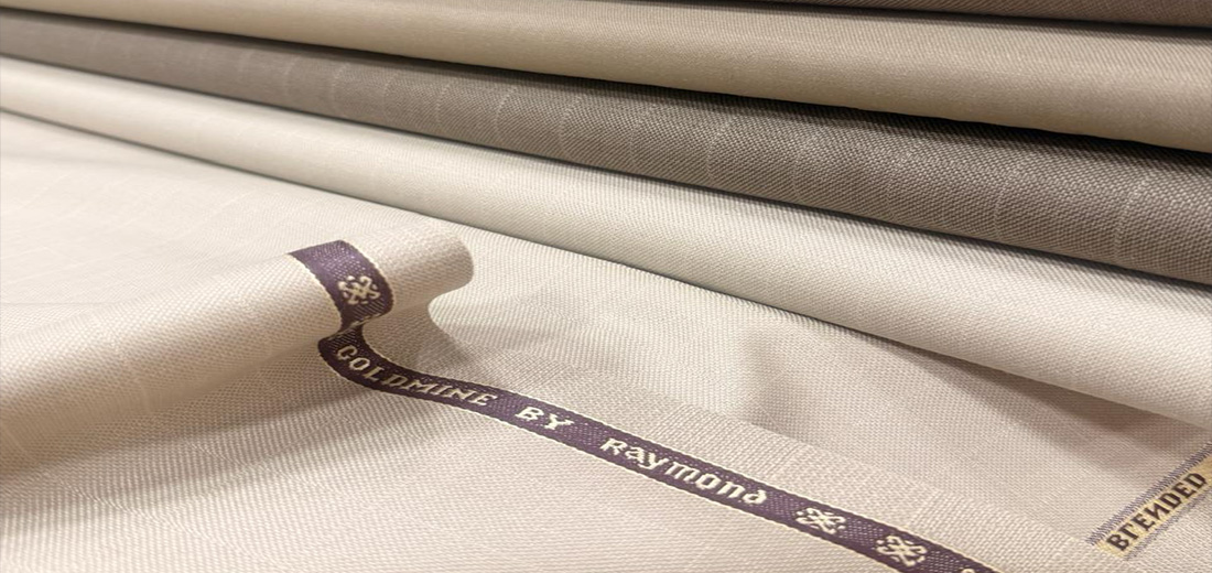 Cream Raymond suiting rolled to show the Raymond selvedge tape