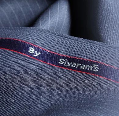 Navy pinstripe suiting with the By Siyaram's selvedge woven in red and white