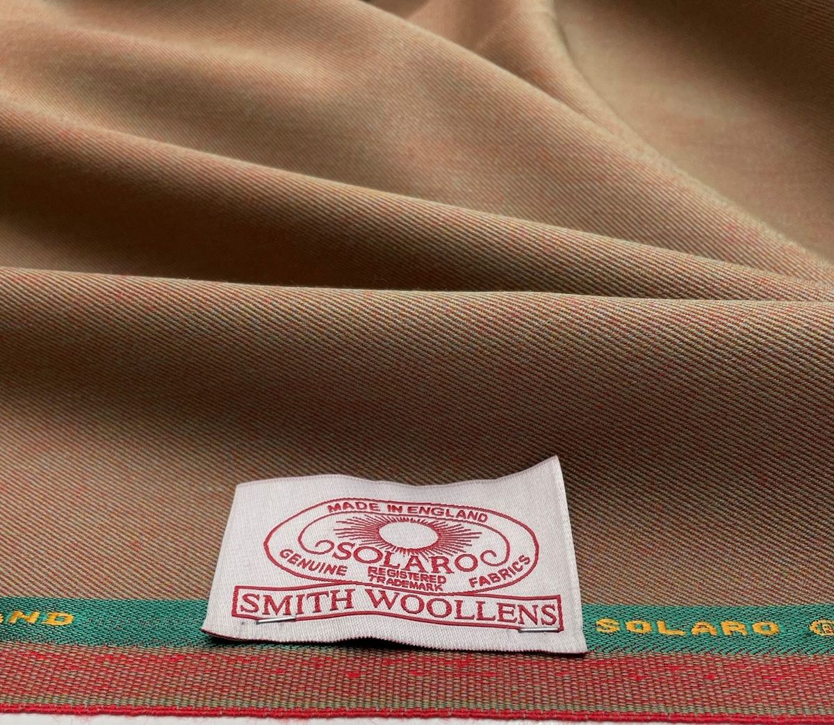 Tan Smith Woollens Solaro cloth turned to show its red reverse