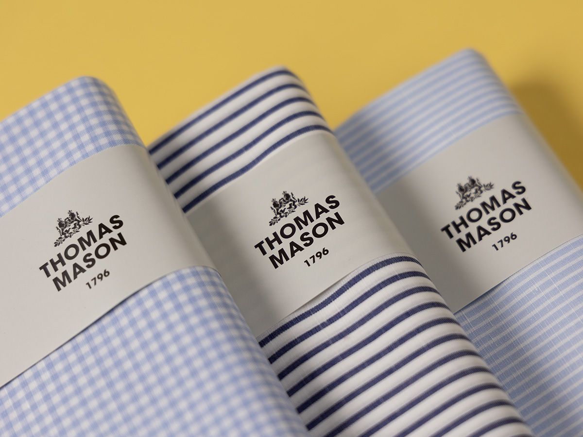 Three rolled Thomas Mason shirtings in lilac check and navy stripe, banded with the house label